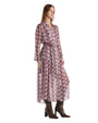 A woman is wearing a long dress featuring a vibrant, patterned print, highlighting its elegant design and style.