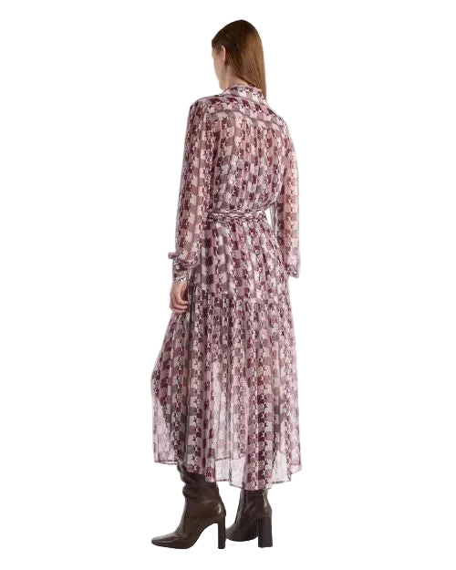 Back view of a woman in a patterned dress, showcasing the design and flow of the fabric.