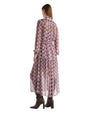 Back view of a woman in a patterned dress, showcasing the design and flow of the fabric.