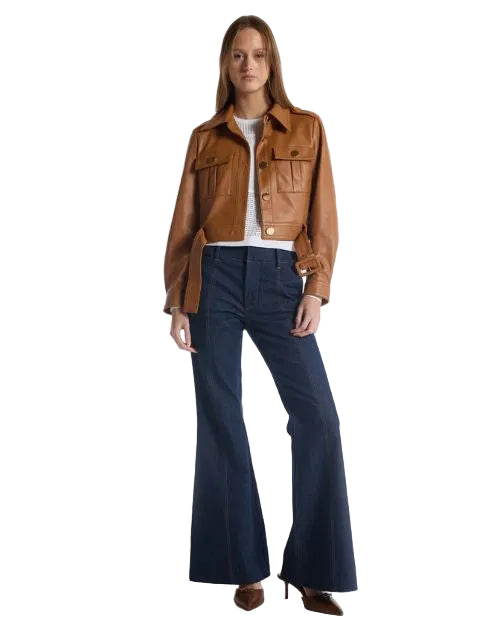 A woman in a stylish leather jacket paired with flared jeans, embodying a trendy, casual look.