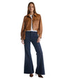 A woman in a stylish leather jacket paired with flared jeans, embodying a trendy, casual look.