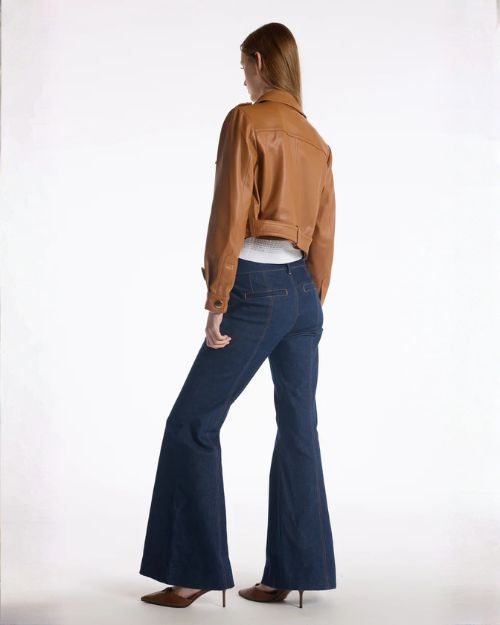 Back view of a woman in flared jeans, showcasing the wide leg design and casual style.
