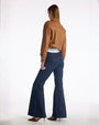 Back view of a woman in flared jeans, showcasing the wide leg design and casual style.