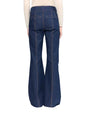 Back view of a woman wearing blue denim pants, showcasing the fit and style of the jeans.