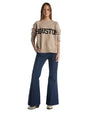 A woman is wearing a sweater with the word "Houston" prominently featured on the front.
