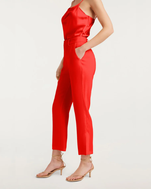 View of a red satin top and matching cropped pants with nude heels.