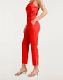 View of a red satin top and matching cropped pants with nude heels.