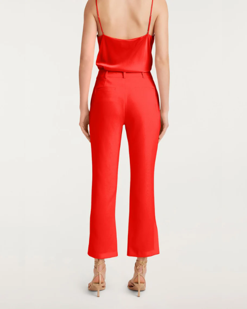 Back view of a red satin top and matching cropped pants with nude heels.