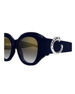 A pair of sunglasses featuring a stylish metal ring on the side for added design and flair.