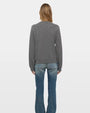 Back view of gray crew neck knit sweater with long sleeves