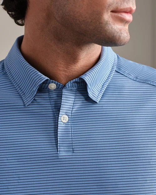 Close-up of a blue striped performance polo shirt featuring a classic collar, two-button placket, and fine horizontal stripe pattern.