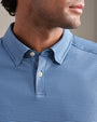 Close-up of a blue striped performance polo shirt featuring a classic collar, two-button placket, and fine horizontal stripe pattern.
