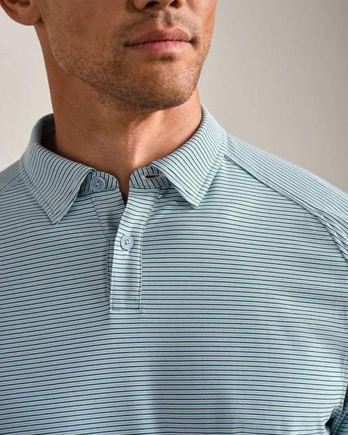 Close-up of a light blue striped performance polo shirt featuring a classic collar, two-button placket, and fine horizontal stripe pattern.