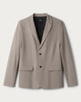 Men's taupe tailored blazer with notch lapel, two-button front closure and flap pockets on a light neutral background.