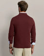 Back view of a men's burgundy mock neck quarter-zip knit sweater with ribbed cuffs and hem