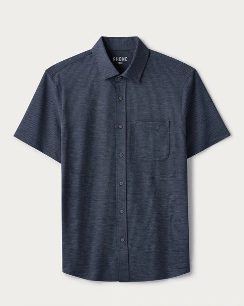 Navy short-sleeve button-down shirt with a classic collar, chest pocket, textured fabric, and tailored fit displayed on a light gray background.