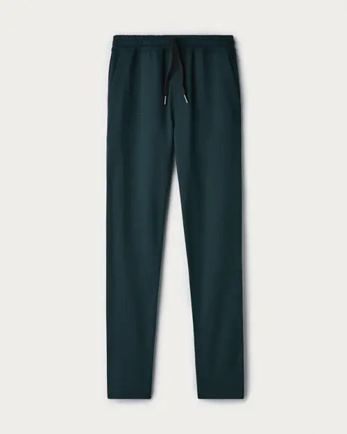 Dark teal jogger pants with a drawstring waistband and tapered leg design, displayed on a light neutral background.
