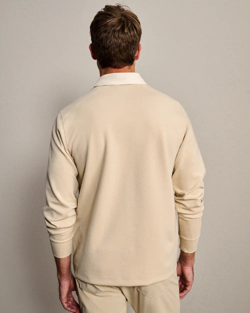 Back view of a men's beige long-sleeve polo shirt with ribbed cuffs and classic collar.