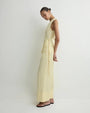 Side view of a light yellow sleeveless wrap top with tie waist and matching wide-leg cropped pants