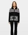 Black and white Fair Isle knit zip cardigan with geometric snowflake pattern