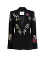A black blazer with floral embellishments against a white background. 