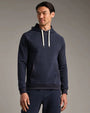 Person wearing a navy pullover hoodie with long sleeves, adjustable drawstring hood, kangaroo pocket, and matching navy jogger pants in a studio setting.