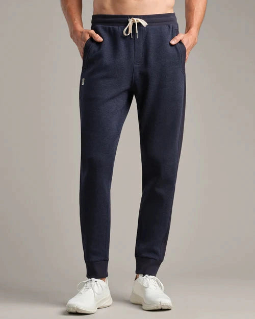 Navy jogger sweatpants with an elastic waistband, adjustable drawstring, tapered leg, ribbed cuffs, and side pockets.