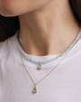 Necklace with teardrop pendant worn by a person on a white background