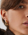 Close up of model's side face wearing Florence earring.  One earring gives illusion of two earrings stacked together.