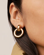 Close up shot of model's side face showing the Puffy Faye earring.