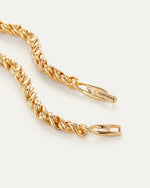 Zoomed in image of the gold braided necklace clasp with the Jenny Bird logo on it. 