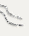 Up-close image of the braided silver necklace clasp opened with the Jenny Bird logo on it.