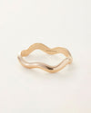 A gold bracelet with a stylish wave pattern, highlighting its unique and contemporary design.
