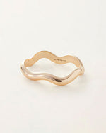 A gold bracelet with a stylish wave pattern, highlighting its unique and contemporary design.