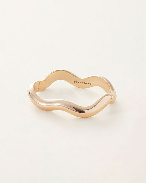 A gold bracelet with a stylish wave pattern, highlighting its unique and contemporary design.