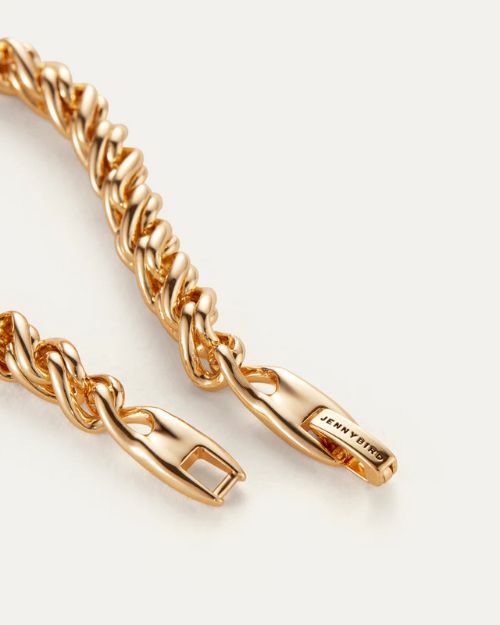 Up close image of a gold thick twisted braided chain clasp with the Jenny Bird logo on one end