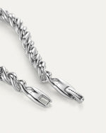 Zoomed in picture of a silver twisty braided bracelet clasp with the words Jenny Bird on the clasp. 