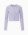Light lavender pointelle knit cardigan with scalloped trim, long sleeves, and a button-front closure displayed on a white background.