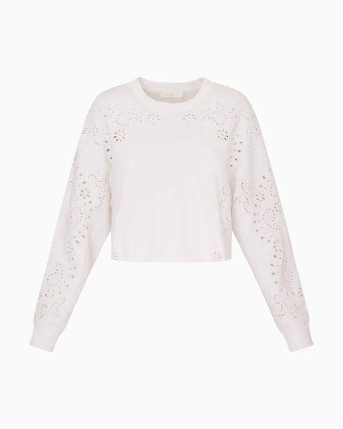 A white cropped sweatshirt with eyelet-style cutout detailing across the shoulders and sleeves, long sleeves with ribbed cuffs, and a relaxed fit.