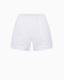 White shorts with an elastic waistband and eyelet-style cutout detailing along the hem.