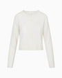 White lightweight knit cardigan with a crew neckline, long sleeves, and concealed button-front closure displayed on a plain white background.