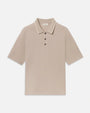Beige short-sleeve polo shirt featuring a classic collar, contrast tipping detail, and a three-button placket on a light grey background.