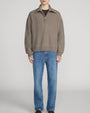 Taupe quarter-zip knit sweater featuring a relaxed fit, ribbed trims, and a wide collar, styled with blue straight-leg jeans on a light grey background.