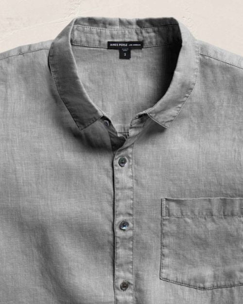 Gray linen long sleeve shirt with a button-down collar, shown in close-up for texture and detail.