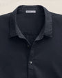 Close-up image of a button-up shirt made of cotton, highlighting the button-down collar design.
