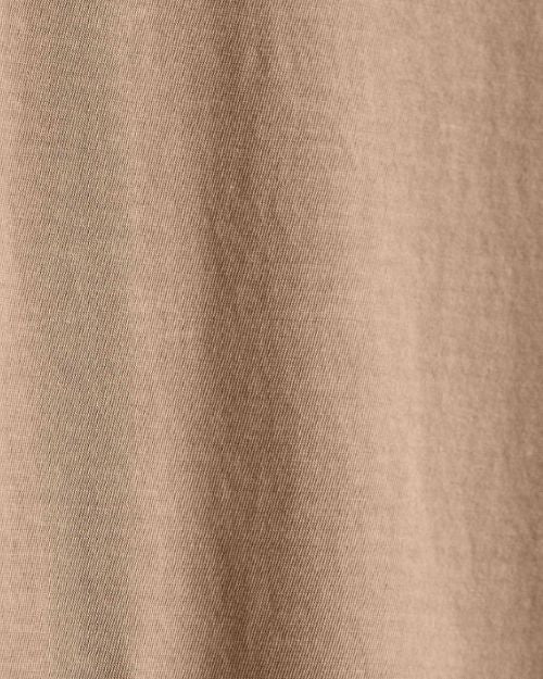 Close-up of cotton fabric, showcasing the texture of a coffee-colored crew neck short sleeve shirt.