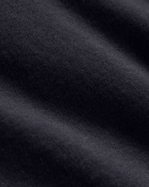 Close-up of a deep colored short sleeve crew neck shirt.