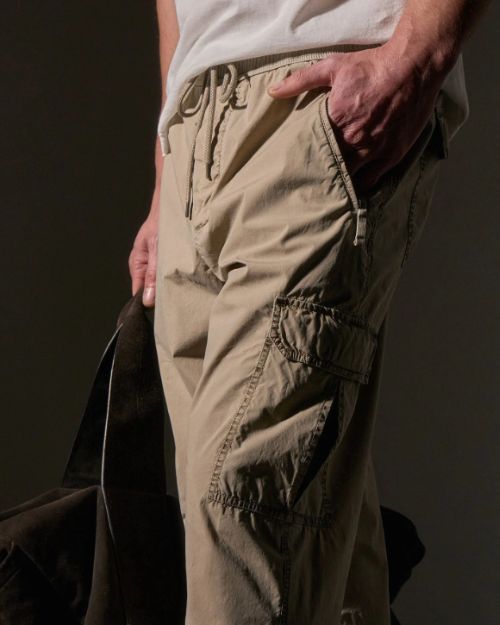 A man in a white shirt paired with cargo pants, highlighting the comfortable Parachute Poplin Cargo material.