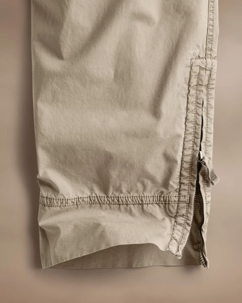 Side perspective of Parachute Poplin Cargo pants with zippers, highlighting their practical design and contemporary style.