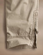 Side perspective of Parachute Poplin Cargo pants with zippers, highlighting their practical design and contemporary style.